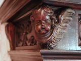 a close up of a clock with a face on it