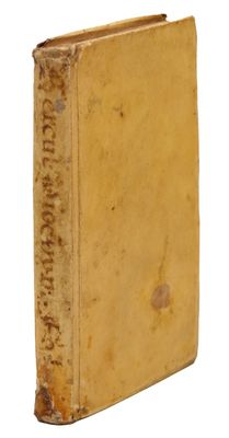 an old yellow book with writing on it sitting on a white surface