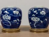 two blue vases sitting next to each other on a table