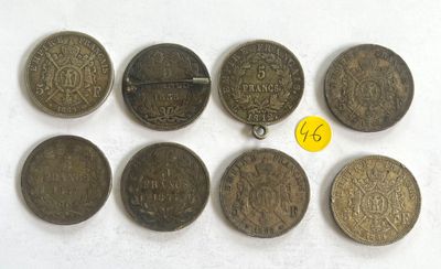 a group of old coins sitting on top of a white surface
