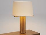 a wooden table with a lamp on top of it