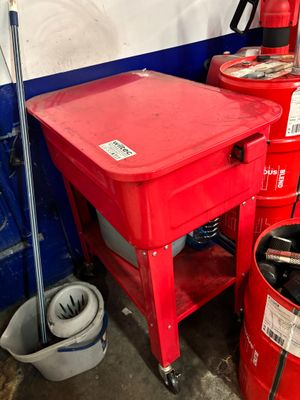 a red table with a red bucket on top of it