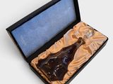a bottle of liquor in a box on a white surface