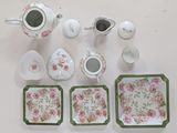 a table with a tea set and cups and saucers on it