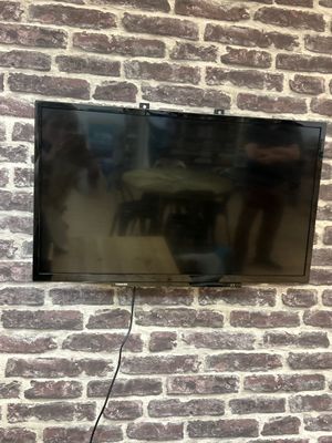 a flat screen tv mounted on a brick wall