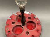a red object with a glass ball on it
