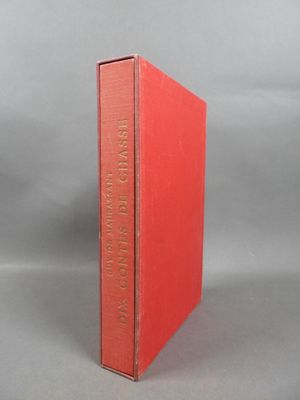 an orange book sitting on top of a table next to a gray background