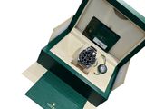 a box with a watch inside of it on a white surface