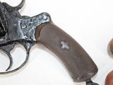 a gun that is sitting next to a peach on a table