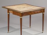 a small table with a marble top and brass legs