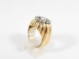 a close up of a gold and diamond ring on a white surface
