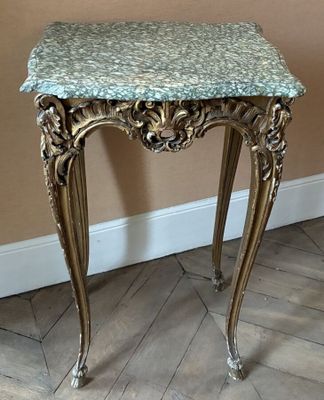 a small table with a marble top on a wooden floor