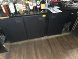 a lot of liquor bottles on the counter in the kitchen