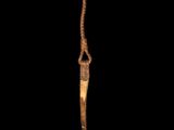 a close up of a knife with a long blade on a black background