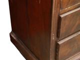 a wooden cabinet with three drawers on it