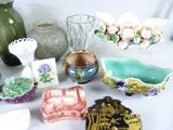 many different vases and bowls on the table