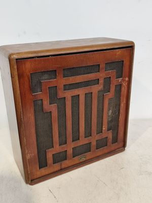 une vieille radio posée sur un meuble blanc
