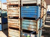 a stack of blue and white crates in the dirt