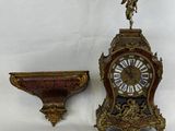 a clock that is sitting next to a shelf