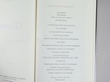 someone is holding a book open to a page with a list on it