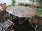 a wooden table and six chairs on a wooden deck
