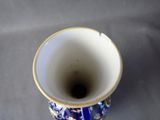 a blue and white vase sitting on a table
