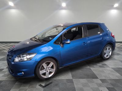 a blue car is parked on a checkered floor in a garage