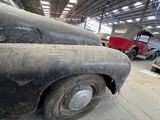 an old truck that is sitting in a garage