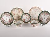 an image of a group of plates and bowls on a white surface