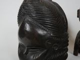 a black mask sitting on top of a table next to other items