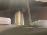 a metal shelf with dishes on it in a kitchen