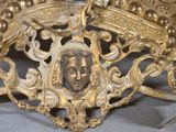 a gold crown with a picture of a woman on it