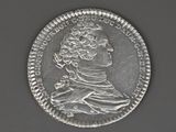 une vieille pièce d'argent sur laquelle figure le portrait d'un homme