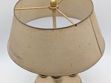 a lamp that has a beige shade on it