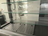 a glass display case in the middle of a kitchen