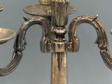 a silver candle holder with a pineapple on top of it