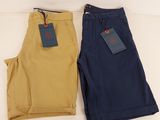 two pairs of men ' s pants on a white surface