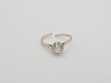 an 18k white gold ring with a round brilliant cut diamond