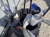 a close up of a golf bag with clubs in it