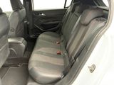 the back seats of a white car with black trims and red accents