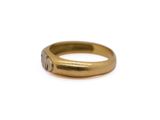 a close up of a gold ring on a white surface