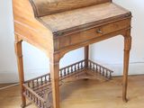 a wooden desk with a roll top on top of it