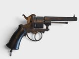 an old revolver with a wooden handle on a white surface