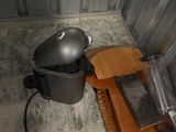a pot and a pan on the floor next to a trash can