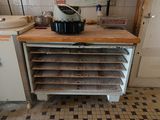 a kitchen with a stove, oven, sink, and cabinets