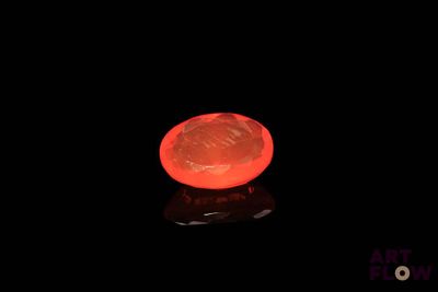 a red frisbee that is glowing in the dark