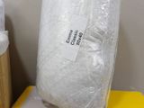 a white pillow sitting on top of a box in a room