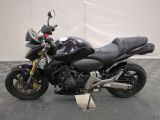 a picture of a black motorcycle parked on a checkered floor