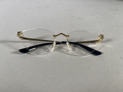 pair of glasses on a table with a white background