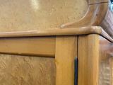 a close up of a bed with a wooden headboard